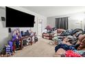 Spacious living room featuring a comfortable sofa, large screen TV, and neutral carpet at 1004 E 8Th Ave, Gastonia, NC 28054
