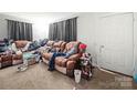 Spacious living room featuring a comfortable sofa and neutral carpet at 1004 E 8Th Ave, Gastonia, NC 28054