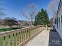Side porch with wooden railing and view of the yard at 1038 Gold Mine Dr, Catawba, NC 28609