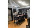 Modern kitchen with dark cabinetry, stainless steel appliances, and a central island with seating at 114 Wayne Ave, Kannapolis, NC 28081