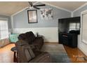 Comfortable living room featuring a large sectional sofa, entertainment center, and vaulted ceilings at 114 Wayne Ave, Kannapolis, NC 28081