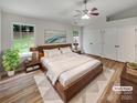 Staged bedroom with vaulted ceiling, hardwood floors, and ample closet space at 12307 Poplar Forest Dr, Charlotte, NC 28278