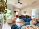 Comfortable living room with a glass coffee table, a modern ceiling fan, and hardwood floors at 125 Todd Nw Dr, Concord, NC 28025