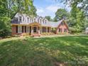 Charming brick home featuring a well-manicured lawn and dormer windows for added natural light at 1518 Appaloosa Way, Gastonia, NC 28056