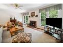 Cozy living room with a fireplace, large windows, and comfortable seating creating a warm atmosphere at 1518 Appaloosa Way, Gastonia, NC 28056