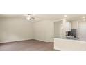 Bright living area with modern wood flooring and a ceiling fan, adjacent to a kitchen area with granite countertops at 1518 Doran Ter, Richburg, SC 29729