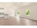 Open-concept living area featuring wood floors, natural light, and access to the outdoors through a sliding glass door at 1518 Doran Ter, Richburg, SC 29729