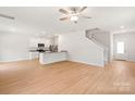 Open-concept living space featuring modern flooring, neutral paint, and staircase at 1564 Doran Ter, Richburg, SC 29729