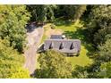 Spacious home with a large yard and long driveway, surrounded by lush green trees at 1738 Charlotte Hwy, Lancaster, SC 29720