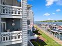 Exterior shot of the condo with beautiful waterfront views, multiple balconies, and lush landscaping at 18679 Vineyard Point Ln, Cornelius, NC 28031