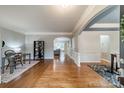 Inviting living room featuring hardwood floors, a modern design, and an open layout with ample natural light at 211 Tyndale Ct, Waxhaw, NC 28173