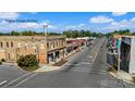 Commercial buildings in a small town center along a street with a water tower in the background at 231 Basildon St # 1021, Lancaster, SC 29720