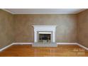 Bright living room with a brick fireplace, hardwood floors, and freshly painted walls at 2605 Camelot Dr, Rock Hill, SC 29732