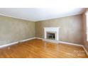 Cozy living room features hardwood floors and fireplace, perfect for relaxing at 2605 Camelot Dr, Rock Hill, SC 29732