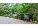 View of the home exterior, driveway and the surrounding lush greenery at 2951 Evergreen Trl, Vale, NC 28168