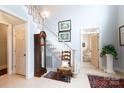 Inviting foyer featuring hardwood floors, a classic grandfather clock, and staircase with white wooden railing at 2972 Kaneland Ct, Rock Hill, SC 29732
