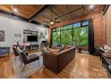Cozy living room featuring hardwood floors, large windows, and comfortable seating at 310 Arlington Ave # 409, Charlotte, NC 28203