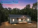 Charming home exterior with inviting front porch set against a dusk sky at 317 N Cemetery St, Richfield, NC 28137