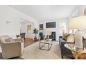 Bright living room with fireplace, large windows, plush carpet, and stylish furniture at 3726 The Plaza None, Charlotte, NC 28205