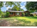 Expansive front lawn showcases a classic brick home with mature landscaping at 4044 Somerdale Ln, Charlotte, NC 28205