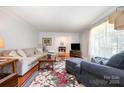 Cozy living room featuring hardwood floors, neutral tones, and abundant natural light at 4044 Somerdale Ln, Charlotte, NC 28205