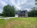 Charming two-story home featuring a blue and gray exterior, a spacious driveway, and a well-manicured lawn at 4435 Cornett Dr # 30, Iron Station, NC 28080