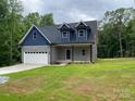 Charming two-story home featuring a blue and gray exterior with a well-manicured lawn at 4435 Cornett Dr # 30, Iron Station, NC 28080