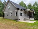 This house features a gray exterior, windows and back porch with metal railings at 4435 Cornett Dr # 30, Iron Station, NC 28080