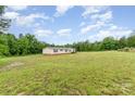 View of house on a large lot with green grass and trees in the background, blue skies and clouds at 4518 Logging Rd, Lancaster, SC 29720