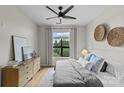 Sunlit bedroom with large window, stylish decor, comfortable bed, and ceiling fan at 482 New Bern Station Ct, Charlotte, NC 28209