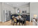 Stylish kitchen featuring stainless steel appliances, two-tone cabinetry, and sleek black countertops at 482 New Bern Station Ct, Charlotte, NC 28209