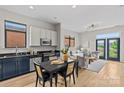 Contemporary open floor plan boasts sleek cabinetry, stainless appliances, and bright living area at 482 New Bern Station Ct, Charlotte, NC 28209