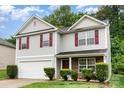 Charming two-story home with red shutters, stone accents and a two car garage in a well-maintained yard at 4837 Autumn Oak Dr, Charlotte, NC 28269
