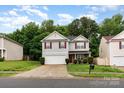 Charming two-story home with red shutters, stone accents and a two car garage on a well-manicured lot at 4837 Autumn Oak Dr, Charlotte, NC 28269
