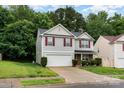 Charming two-story home with red shutters, stone accents and a two car garage in a well-maintained yard at 4837 Autumn Oak Dr, Charlotte, NC 28269