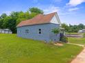 Rear exterior view showing the home's siding, well-maintained lawn, and complementing landscape at 506 N Styers St, Cherryville, NC 28021