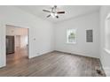Bright living room featuring neutral walls, modern floors, ceiling fan, and natural light from large windows at 506 N Styers St, Cherryville, NC 28021