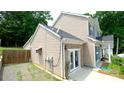 Rear view of a home with a small yard, showing access to the backyard through glass doors at 7046 Dorn Cir, Charlotte, NC 28212