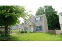 Attractive exterior view of a home with a well-maintained lawn and mature trees, showcasing curb appeal at 7046 Dorn Cir, Charlotte, NC 28212