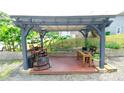 Cozy outdoor pergola with seating and a hammock, perfect for relaxing and entertaining at 7046 Dorn Cir, Charlotte, NC 28212