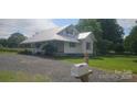 This home features a gravel driveway, manicured lawn, and covered porch, perfect for relaxing at 804 N Main St, Oakboro, NC 28129