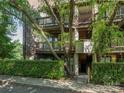 Exterior view of the condo with wooded details, balconies, and well-maintained landscaping at 8208 Cedar Glen Dr, Charlotte, NC 28212
