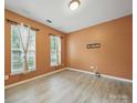 Cozy bedroom features modern wood-look flooring and bright windows at 9564 Kings Parade Blvd, Charlotte, NC 28273