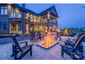 Backyard patio featuring a fire pit with outdoor seating and a covered deck area overlooking the landscape at 0 Edgewater Dr # 107, Norwood, NC 28128