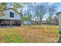 A large, grassy backyard area with a shed and other storage at 1003 S Ridge Ave, Kannapolis, NC 28083