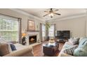 Inviting living room with a cozy fireplace, plush seating, and large windows providing ample natural light at 10306 Madison Park Dr, Charlotte, NC 28269