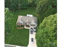 Aerial view of a brick home with a manicured lawn and driveway holding 3 vehicles at 104 Laura Ct, Cherryville, NC 28021