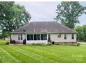 Spacious backyard featuring a lush lawn and a screened-in porch and patio area at 104 Laura Ct, Cherryville, NC 28021