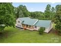 A beautiful home is showcased from above with a well-maintained lawn and mature trees at 105 Pelican Ct, Mooresville, NC 28117