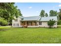 Charming exterior featuring a covered porch, freshly painted siding, and updated windows at 105 Pelican Ct, Mooresville, NC 28117
